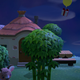 A balloon with a gift attached drifts over a house in Animal Crossing: New Horizons.